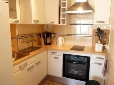 a kitchen with white cabinets and a black oven at Stylish one bedroom apartment in Central Cannes just off the Croisette and near beaches - 680 in Cannes