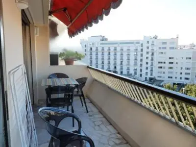 a balcony with tables and chairs on a building at Stylish one bedroom apartment in Central Cannes just off the Croisette and near beaches - 680 in Cannes