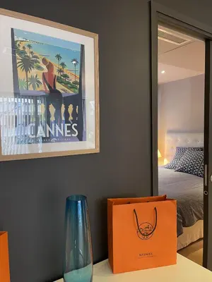 a vase sitting on a table in front of a mirror at Magnifique Modern appartement avec terrasse FERN12 in Cannes
