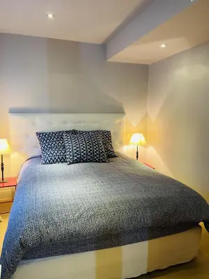 a bedroom with a large bed with two lamps at Magnifique Modern appartement avec terrasse FERN12 in Cannes