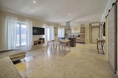 a kitchen and living room with a table and chairs at IMMOGROOM- Apartment 70m2 - Renovated - Wifi - AC - Close to everything in Cannes