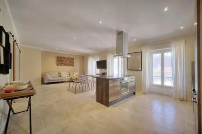 a large living room with a kitchen and a dining room at IMMOGROOM- Apartment 70m2 - Renovated - Wifi - AC - Close to everything in Cannes