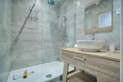 a bathroom with a sink and a shower and a tub at IMMOGROOM- Apartment 70m2 - Renovated - Wifi - AC - Close to everything in Cannes