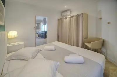 a bedroom with a bed with two towels on it at IMMOGROOM- Apartment 70m2 - Renovated - Wifi - AC - Close to everything in Cannes