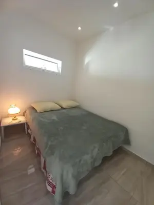 a bedroom with a bed in a room with a window at Le Trident B in Cannes