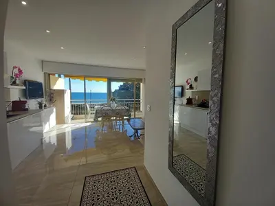 a mirror in a living room with a view of the ocean at Le Trident B in Cannes