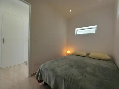a bedroom with a large bed and a window at Le Trident B in Cannes