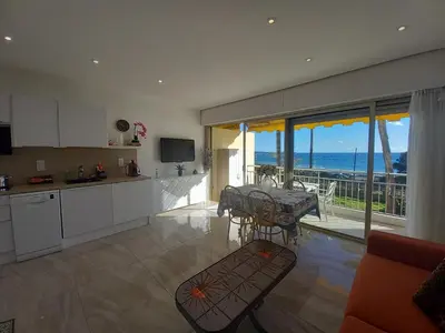 a kitchen and dining room with a view of the ocean at Le Trident B in Cannes