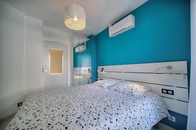 a blue bedroom with a bed and a blue wall at Elégant 2 pièces TERRASSE, CARLTON MARTINEZ- Proche CROISETTE A1B238 in Cannes