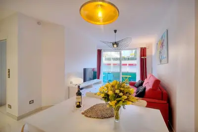a living room with a vase of flowers on a table at Elégant 2 pièces TERRASSE, CARLTON MARTINEZ- Proche CROISETTE A1B238 in Cannes