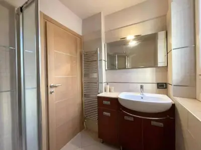 a bathroom with a sink and a mirror and a shower at Appartement Cannes centre ville pour congrès ou vacances à 5 min de la Croisette, plage in Cannes