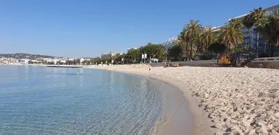a sandy beach with a bulldozer on it next to the water at Appartement Cannes centre ville pour congrès ou vacances à 5 min de la Croisette, plage in Cannes