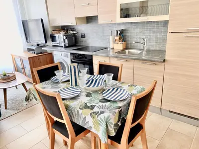 a kitchen with a table with a tablecloth on it at Appartement Cannes centre ville pour congrès ou vacances à 5 min de la Croisette, plage in Cannes