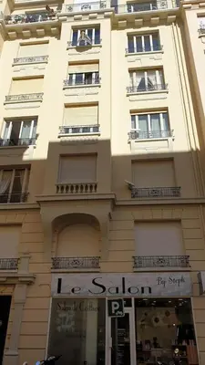 a tall building with a sign in front of it at Appartement Cannes centre ville pour congrès ou vacances à 5 min de la Croisette, plage in Cannes