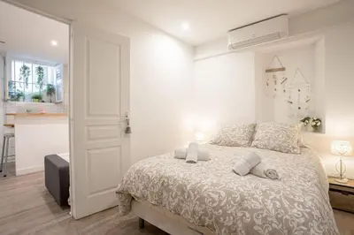 a white bedroom with a bed in a room at Centre Cannes - 5 Mins Des Plages Et Du Palais ! - Joseph Méro in Cannes