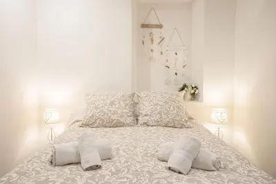 a white bed with two pillows and two lamps at Centre Cannes - 5 Mins Des Plages Et Du Palais ! - Joseph Méro in Cannes