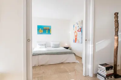 a bedroom with a bed in a white room at 2-Br in high Residential Property in Cannes