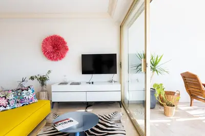 a living room with a yellow couch and a tv at 2-Br in high Residential Property in Cannes