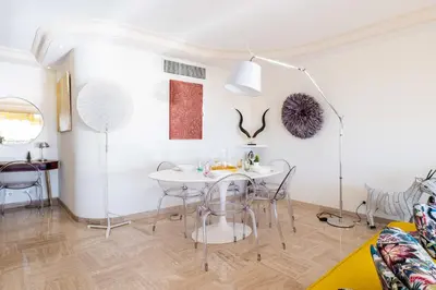 a white dining room with a white table and chairs at 2-Br in high Residential Property in Cannes