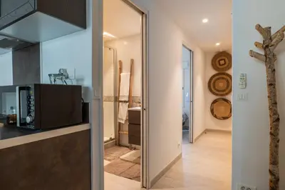 a kitchen with a sliding glass door leading into a hallway at 1-Br apartment in the heart of Cannes in Cannes