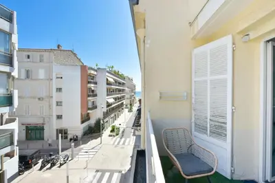 an apartment balcony with a bench and buildings at 1-Br apartment in the heart of Cannes in Cannes