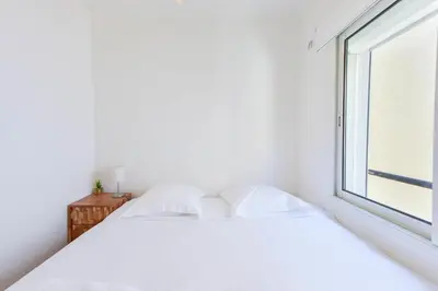 two beds in a bedroom with a window at 1-Br apartment in the heart of Cannes in Cannes