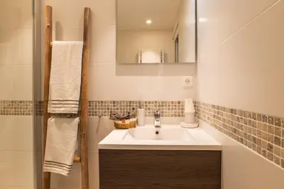 a bathroom with a sink and a mirror at 1-Br apartment in the heart of Cannes in Cannes