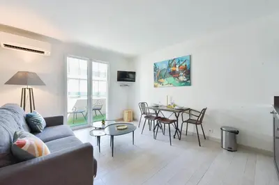 a living room with a couch and a table at 1-Br apartment in the heart of Cannes in Cannes