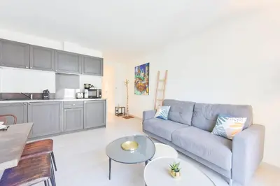 a living room with a couch and a table at 1-Br apartment in the heart of Cannes in Cannes