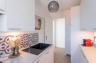 a kitchen with a sink and a counter top at Apartment With Panoramic Sea View, Walk To The Beach - Maréchal Juin by Halldis in Cannes