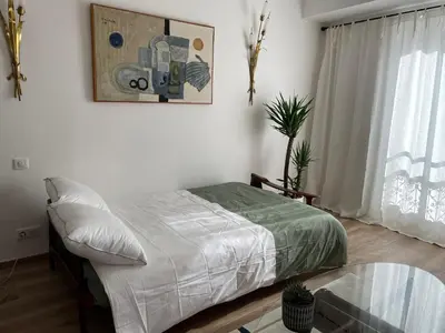 a bedroom with a bed and a glass table at FELIX FAURE PALAIS DES FESTIVALS CROISETTE VIEUX PORT in Cannes
