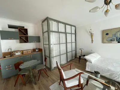 a living room with a bed and a table and a couch at FELIX FAURE PALAIS DES FESTIVALS CROISETTE VIEUX PORT in Cannes