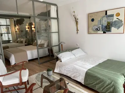a bedroom with two beds and a mirror at FELIX FAURE PALAIS DES FESTIVALS CROISETTE VIEUX PORT in Cannes
