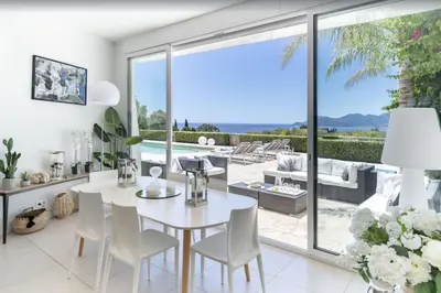 a living room with a couch and a table at FRGK Contemporary Luxury Villa Panoramic Sea View, Pool & Ultra-Fast Wi-Fi in Cannes