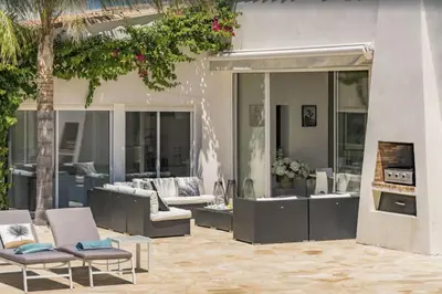 an outdoor patio with couches and a swimming pool at FRGK Contemporary Luxury Villa Panoramic Sea View, Pool & Ultra-Fast Wi-Fi in Cannes