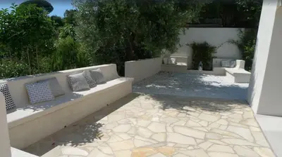 a bench with pillows on it sitting on a patio at FRGK Contemporary Luxury Villa Panoramic Sea View, Pool & Ultra-Fast Wi-Fi in Cannes