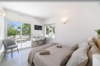 a bedroom with a bed and a chair and a window at FRGK Contemporary Luxury Villa Panoramic Sea View, Pool & Ultra-Fast Wi-Fi in Cannes