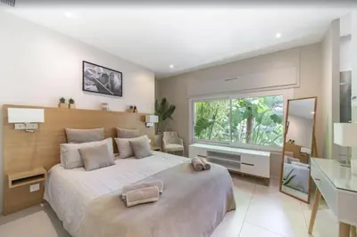 a white bedroom with a large bed and a desk at FRGK Contemporary Luxury Villa Panoramic Sea View, Pool & Ultra-Fast Wi-Fi in Cannes