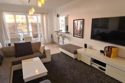 a living room with a large flat screen tv at CENTRE, 3P/TERRASSE , 300 m PLAGES. in Cannes