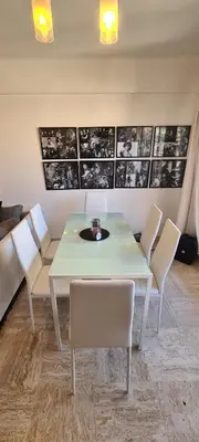 a dining room with a white table and chairs at CENTRE, 3P/TERRASSE , 300 m PLAGES. in Cannes