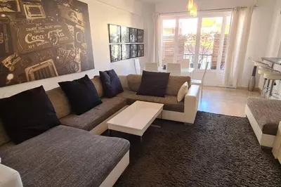 a living room with a couch and a table at CENTRE, 3P/TERRASSE , 300 m PLAGES. in Cannes