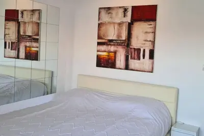 a bedroom with a bed and two paintings on the wall at CENTRE, 3P/TERRASSE , 300 m PLAGES. in Cannes