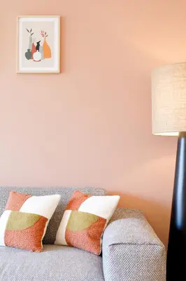 a living room with a gray couch with pillows at Citybeach SOHA- Rue d'Antibes - 2 BdR 2 BthR 1 toil - Clim Terrace Parking Elevator in Cannes