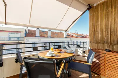 a table and chairs on a balcony with a view at Citybeach SOHA- Rue d'Antibes - 2 BdR 2 BthR 1 toil - Clim Terrace Parking Elevator in Cannes