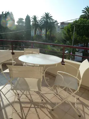 a white table and chairs on a balcony at VILLAS DES LYS in Cannes