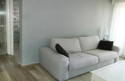 a white couch with two pillows sitting in a living room at VILLAS DES LYS in Cannes