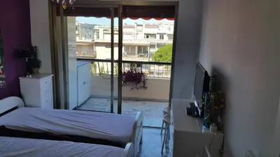 a bedroom with a bed and a view of a balcony at Moderne Appartement Cannes Californie in Cannes