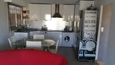 a kitchen with a table and a dining room at Moderne Appartement Cannes Californie in Cannes