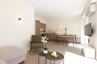 a living room with a couch and a table at Martinez area Superb 1 bed w XXL terrace in Cannes