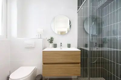a bathroom with a toilet and a sink and a mirror at Martinez area Superb 1 bed w XXL terrace in Cannes